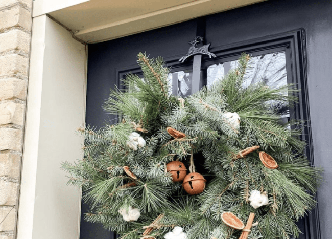 evergreen wreath with cinnamon dried oranges and cotton balls