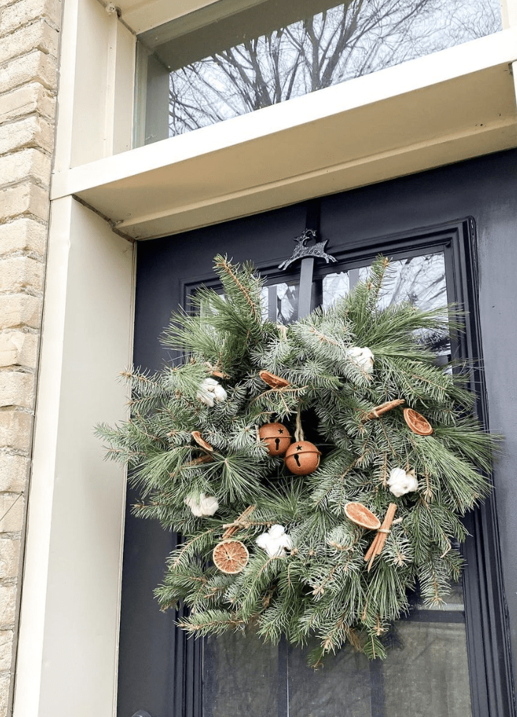 evergreen wreath with cinnamon dried oranges and cotton balls