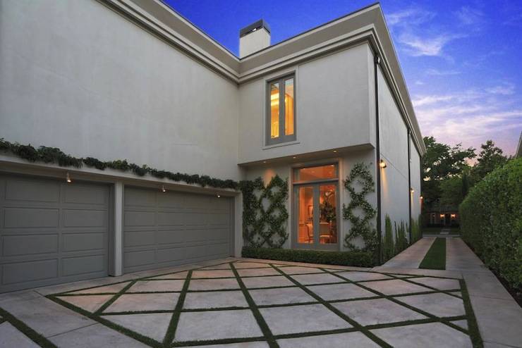 Home with his and her garages featuring gray garage doors.