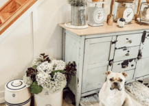 entryway with puppy dog crocks old vintage scales milk painted furniture stairway
