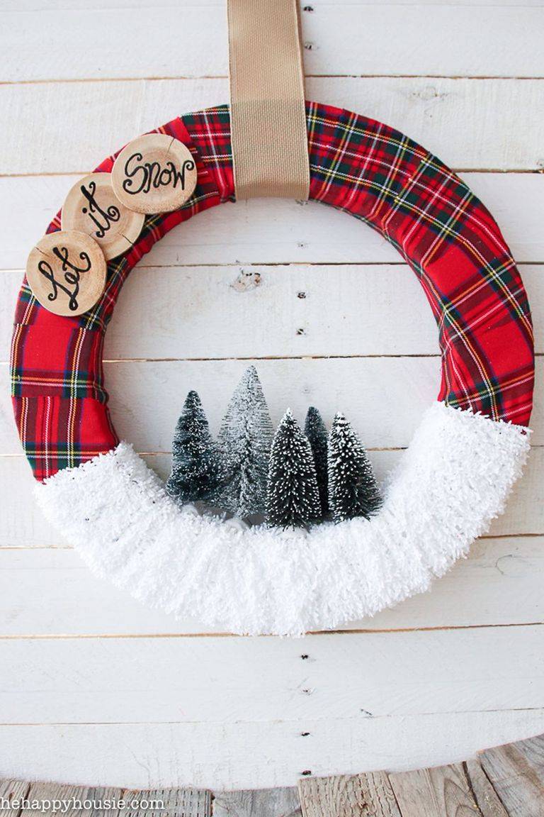 snowy scene wreath with plaid ribbon bottle brush trees and let it snow wood log slices