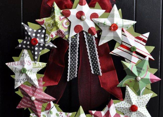 3d paper star wreath hanging on black door