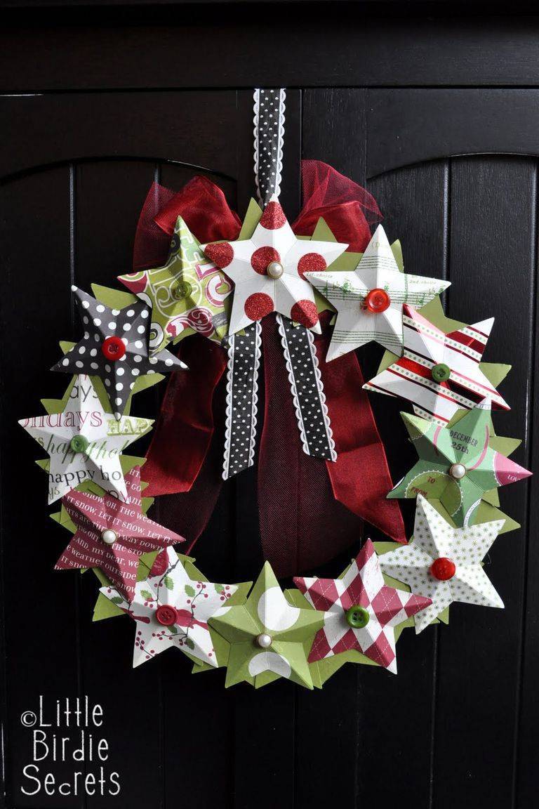 3d paper star wreath hanging on black door