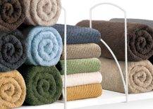 tall shelf dividers with rolled colorful towels in between