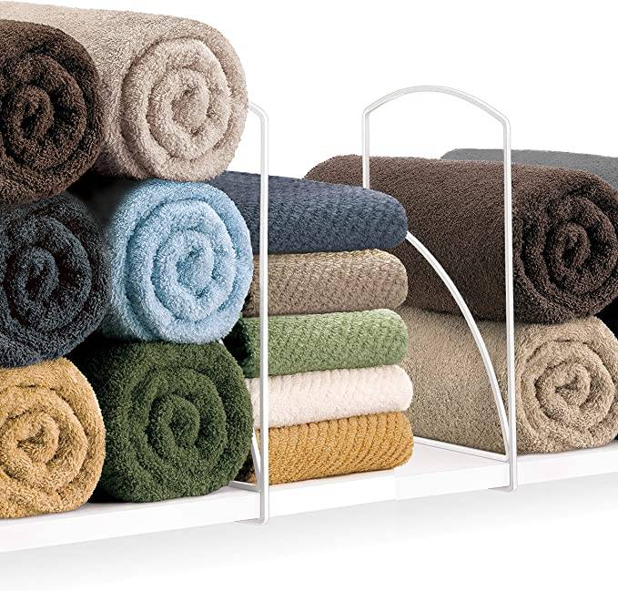 tall shelf dividers with rolled colorful towels in between