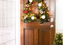 tree shaped evergreen wreath hanging on brown wooden door