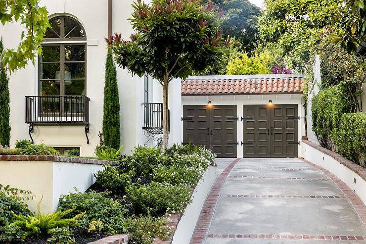 House features dark taupe vintage style garage doors.