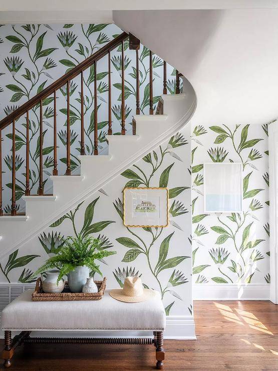 Anna French Savoy Cleo Vine Wallpaper covers a staircase wall positioned behind an ivory linen bench.
