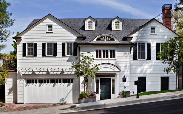 Lovely pale gray colonial home with two car attached garage.