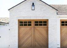 A white brick garage is accented with wooden chevron garage doors.