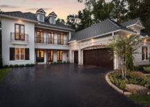 Gorgeous home exterior features sleek white exterior accented with gray shingled roof over black French doors and Juliet balconies as well as an attached 3 car garage.