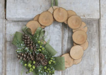 wood log slice wreath christmas with evergreen and green ribbon