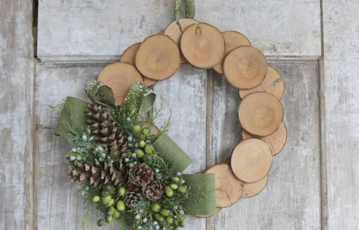 wood log slice wreath christmas with evergreen and green ribbon