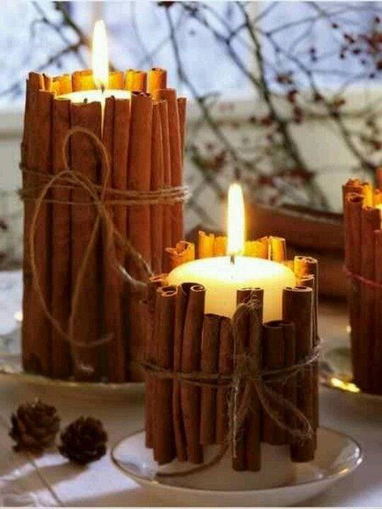 cinnamon sticks wrapped around white candles