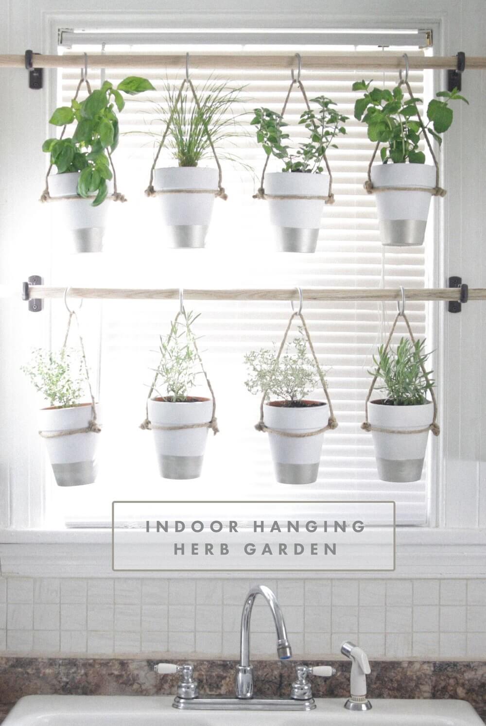 Hanging indoor herb garden over kitchen window sink