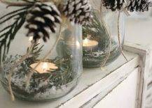 glass jars with candles greenery faux snow and pinecones