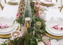 a bright winter table with a red plaid runner, napkins, birch branches, faux Christmas trees and an evergreen runner