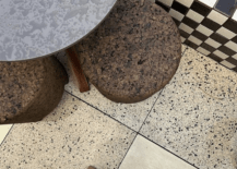 woman's feet in boots on terrazzo floor with checker bench