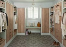 Fabulous closet features light gray walls and Amphora Bell Jar Pendant over gray mosaic tiled floor, Ann Sacks Andy Fleishman's 12 1/8-inch x 12 1/8-inch Neo Terrazzo in Barcelona. Luxurious closet with limed pine finish on cabinets flanking floating bench.