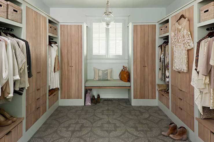 Fabulous closet features light gray walls and Amphora Bell Jar Pendant over gray mosaic tiled floor, Ann Sacks Andy Fleishman's 12 1/8-inch x 12 1/8-inch Neo Terrazzo in Barcelona. Luxurious closet with limed pine finish on cabinets flanking floating bench.