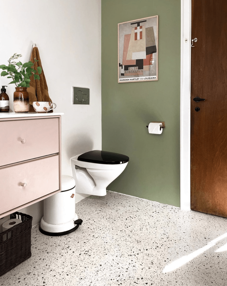 terrazzo floor in bathroom with floating toilet green and pink color scheme