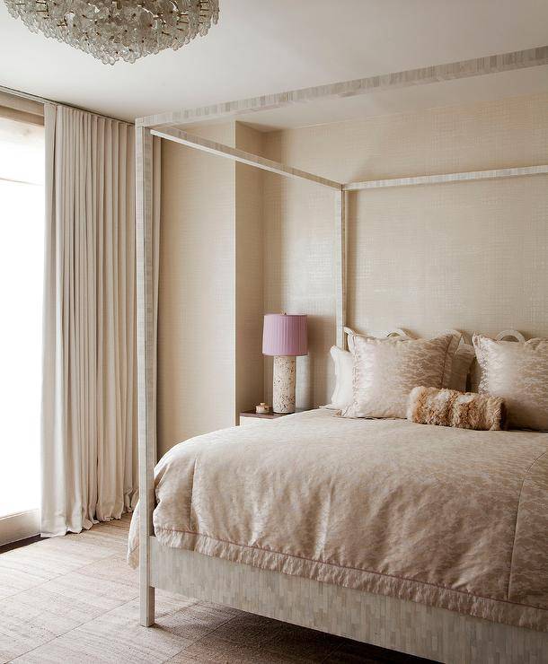 Elegant bedroom features a surf capiz canopy bed placed versus a surf wallpapered wall lit by a surf lamp with a pink pleated lamp shade.