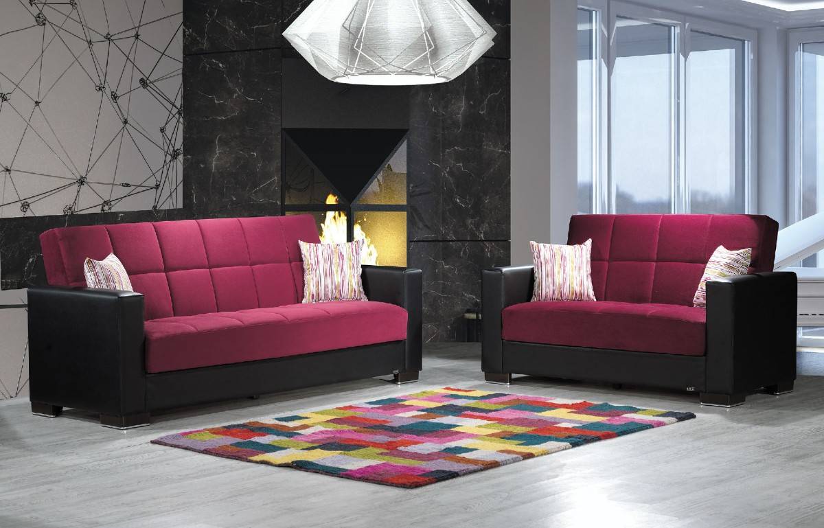 burgundy and black couches with area rug in the middle stone granite fireplace