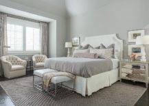 grey bedroom with white cream sitting chairs mirrored nightstand bench large area rug
