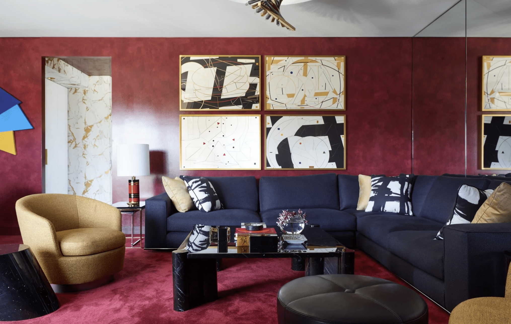 burgundy and navy designed modern living room with gold chair and sectional couch modern wall art