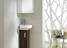 Sleek modern corner sink in a minimalist house.