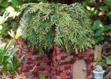 fairy garden house made out of bricks with ceader greenery roof