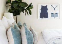 Bedroom features vintage swimsuit art and a bed with blue and cream bedding.