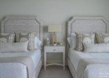 Shared bedroom features two light gray striped headboards with light gray pillows flanking a white nightstand and burlap lamp.