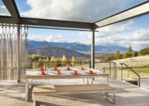 outdoor patio table on wooden balcony with view of mountains