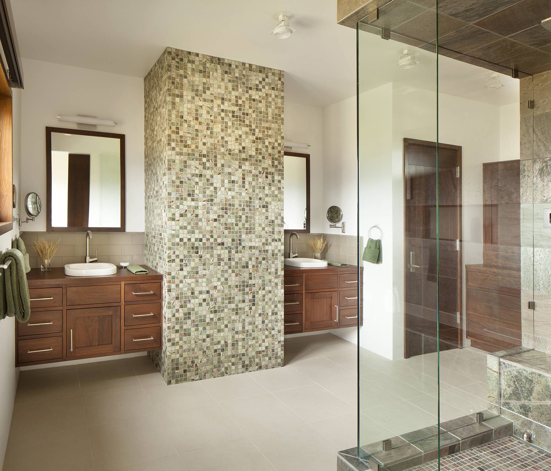 double vanity master bathroom with stone accent wall separating sinks