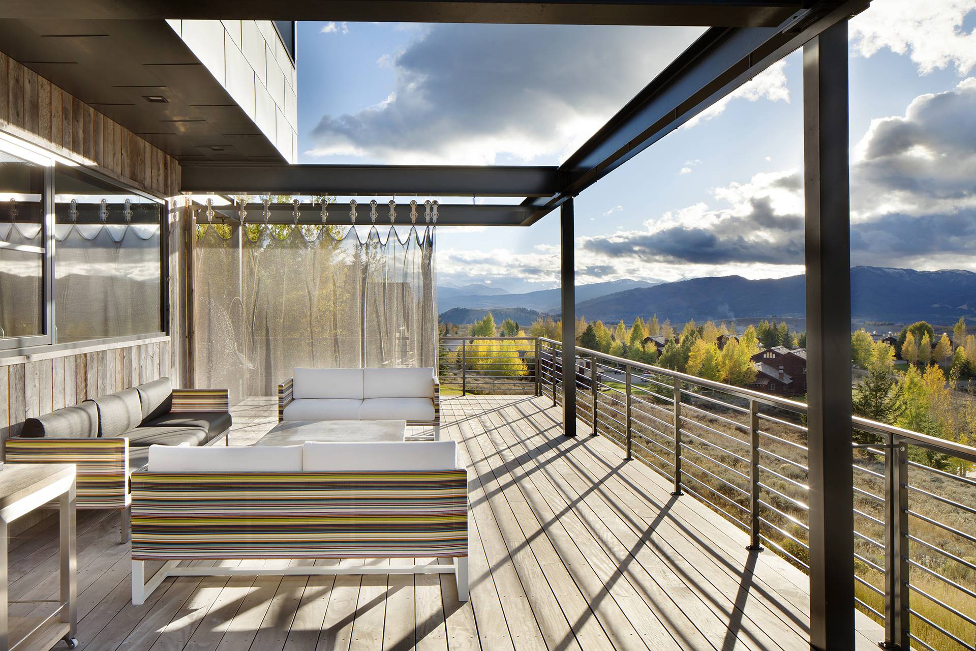 outdoor patio with curtain partition and view of mountains