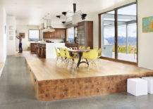raised wooden platform with kitchen table and yellow chairs