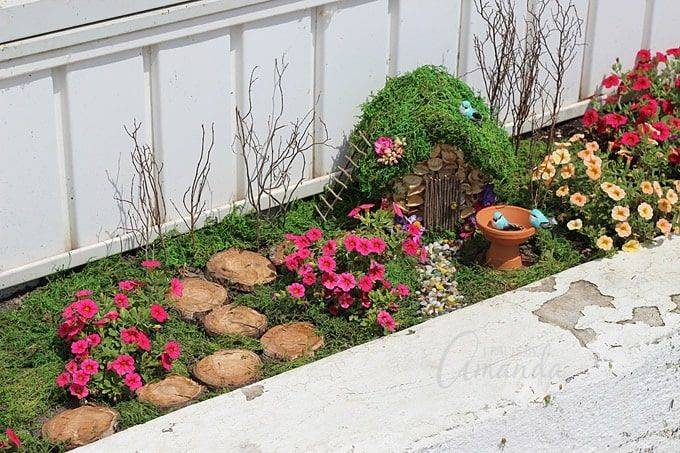 window box fairy garden with moss and flowers