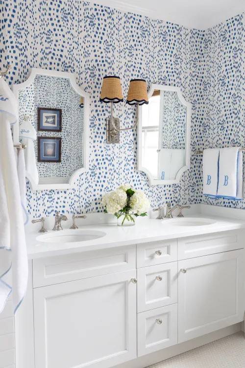 bright blue patterned wallpaper in all white bathroom