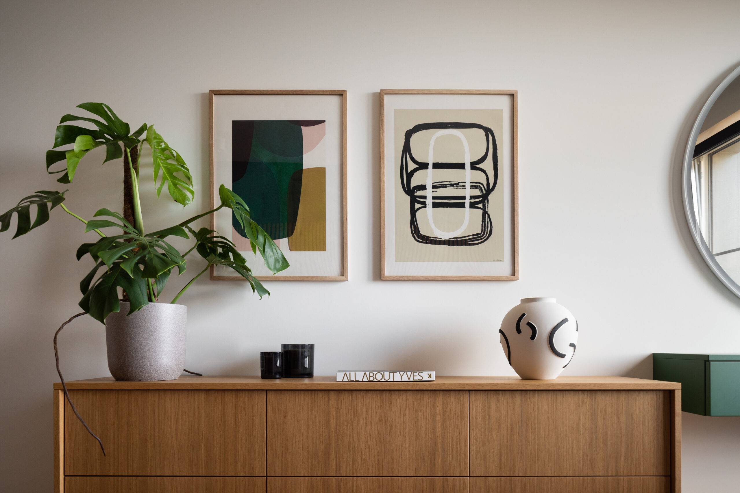 accent table in bedroom with colorful paintings, plants and trinkets