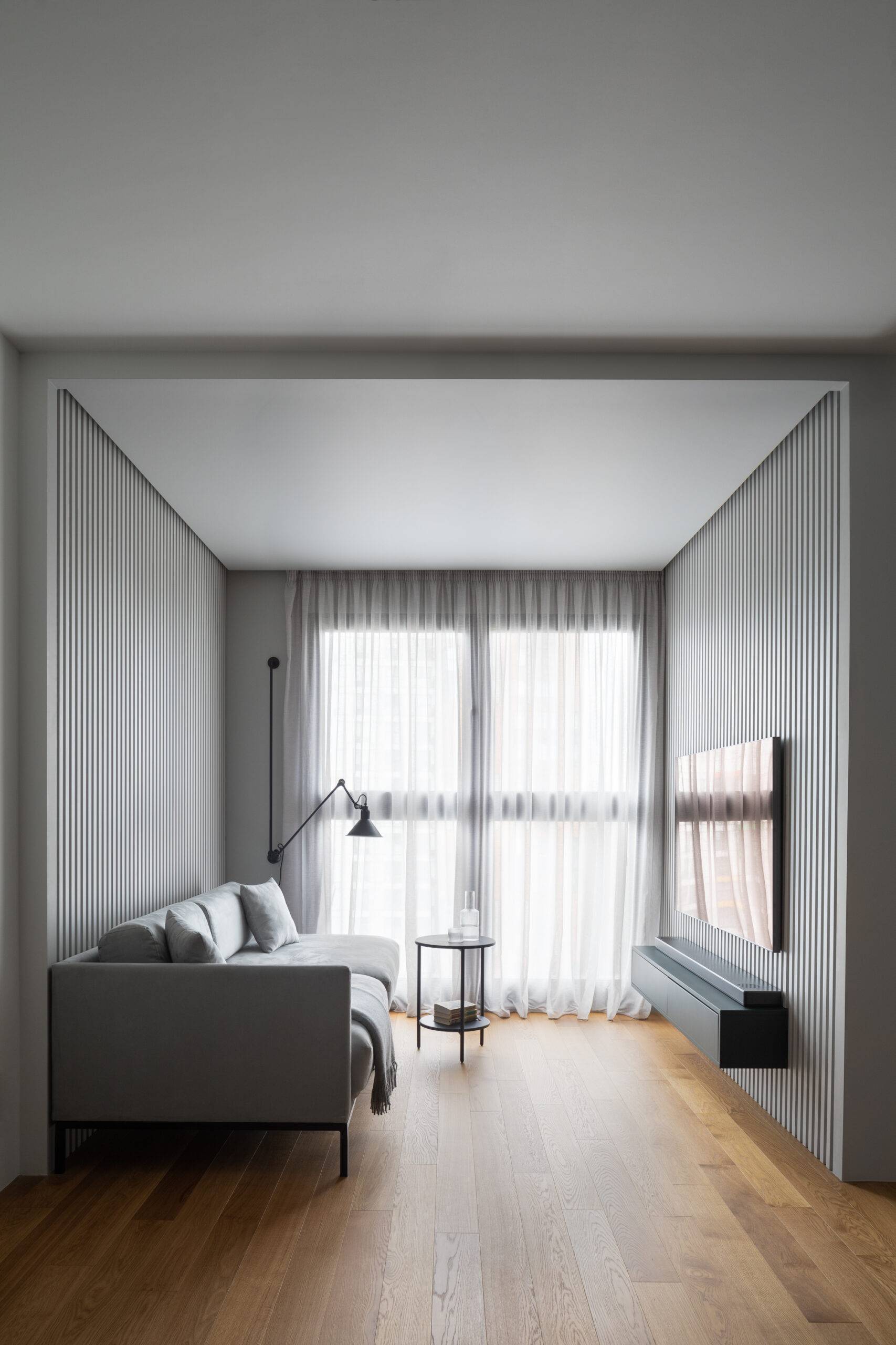 grey and wood living room with large windows