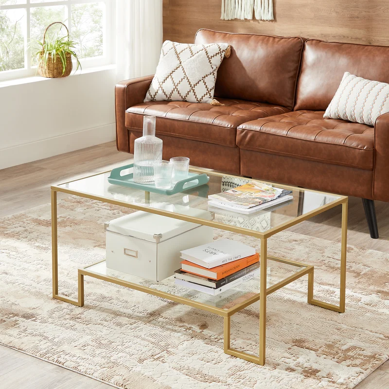 gold coffee table with leather brown couch