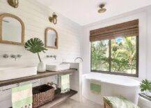 Spa-like white master bath with warm wood accents and tropical greenery