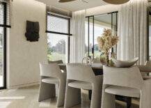 minimalist natural dining room with black sculpture on wall, large natural bouquet in table center