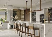 marble kitchen island with wood barstools, minimalist lighting and living room table in background