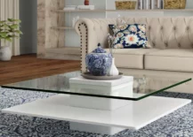 modern glass coffee table with cream tufted couch sofa