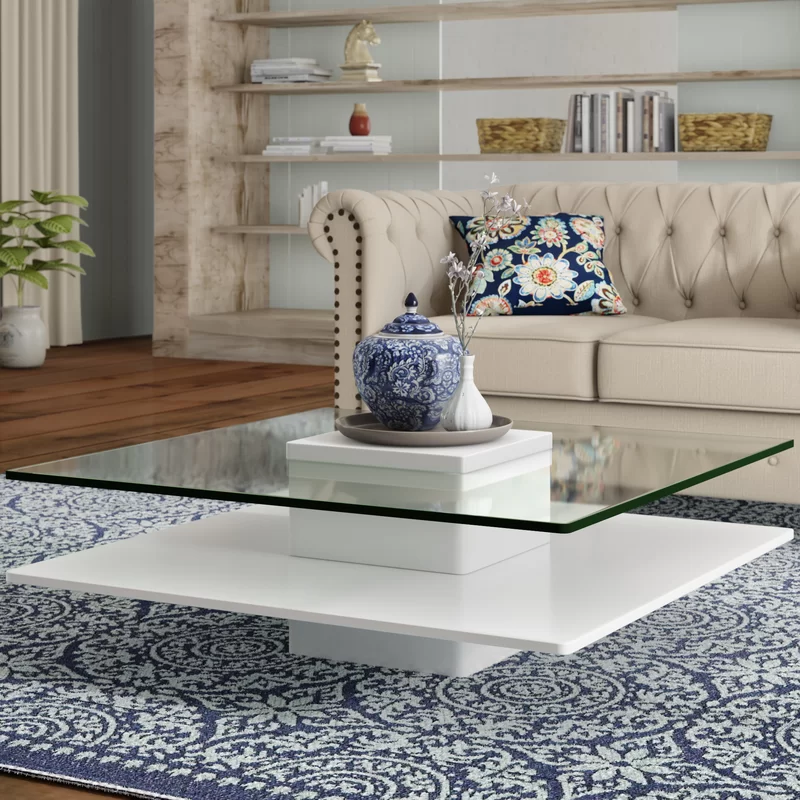 modern glass coffee table with cream tufted couch sofa