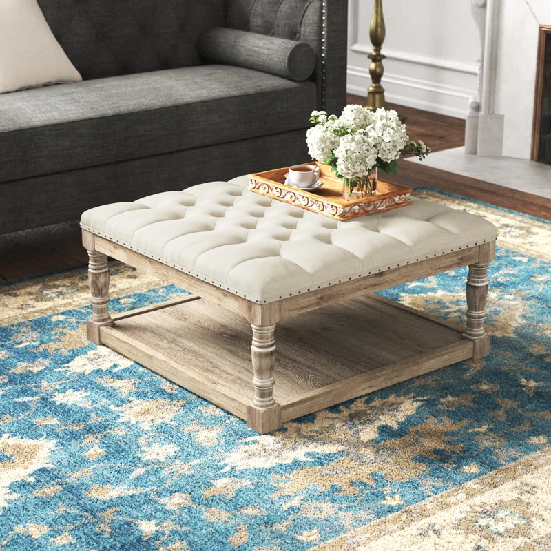 tufted ottoman coffee table with table tray and flowers