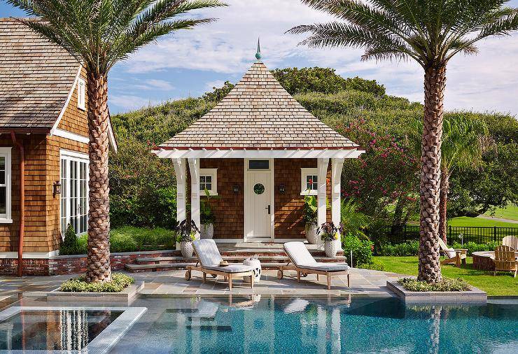 A brown singled pool house accented with a white door.