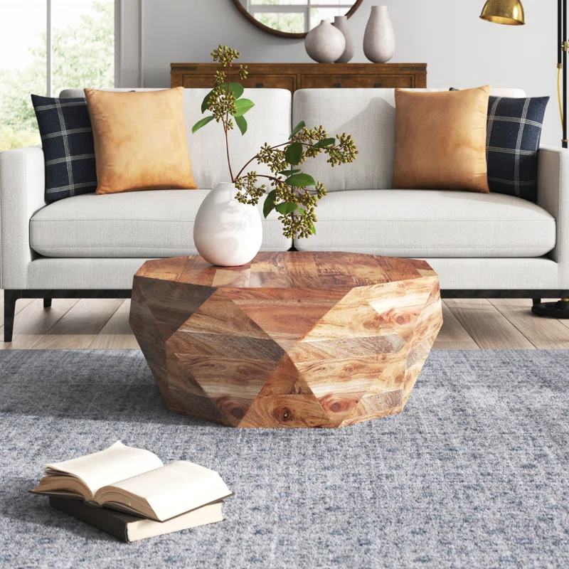 prana coffee table geometric wood shapre with white couch behind